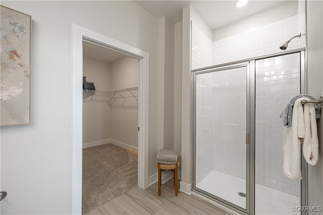 10526 Stony Bluff Dr Unit 308, Ashland, VA 23005 - bathroom featuring a shower stall, baseboards, and a walk in closet