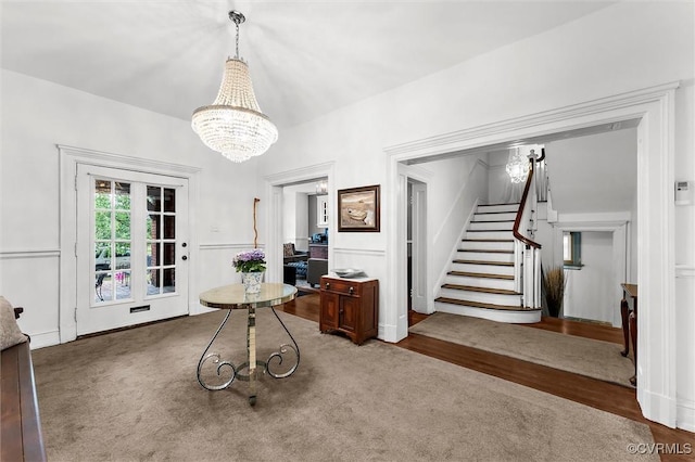 dining room with stairway, a chandelier, and wood finished floors