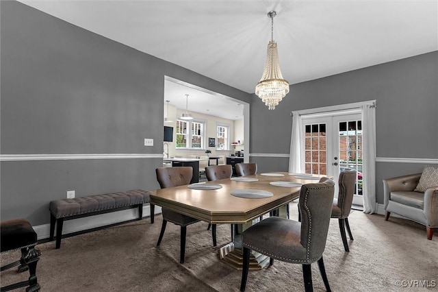 dining room featuring french doors, carpet flooring, a chandelier, and plenty of natural light