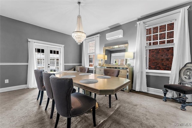 dining room with a wall mounted air conditioner, french doors, a chandelier, and baseboards