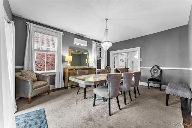 carpeted dining space featuring a wall unit AC, a chandelier, and baseboards