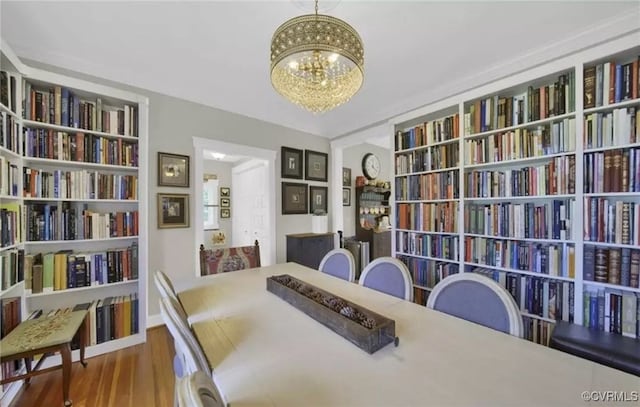 dining area featuring an inviting chandelier and wood finished floors