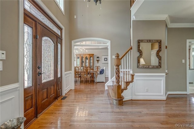 2600 Mulberry Row Rd, Midlothian, VA 23113 - entryway with stairs, light wood-style flooring, a decorative wall, wainscoting, and a chandelier