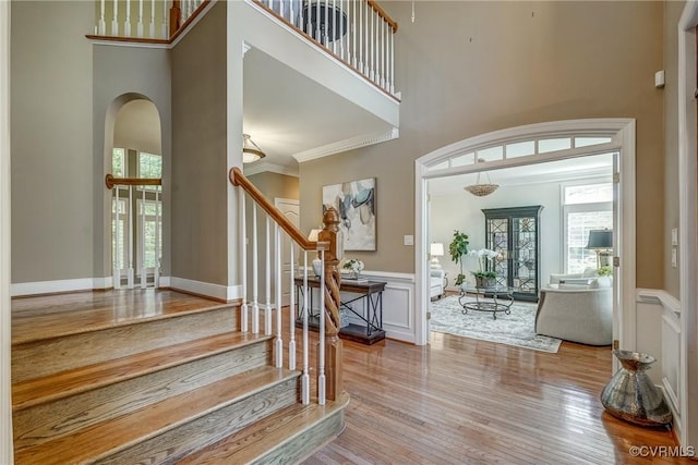 2600 Mulberry Row Rd, Midlothian, VA 23113 - foyer entrance with a high ceiling, wood-type flooring, stairs, wainscoting, and arched walkways