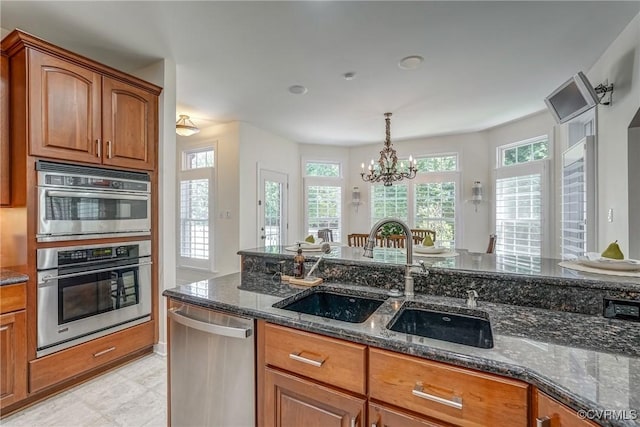 2600 Mulberry Row Rd, Midlothian, VA 23113 - kitchen featuring stainless steel appliances, a sink, brown cabinets, and dark stone counters
