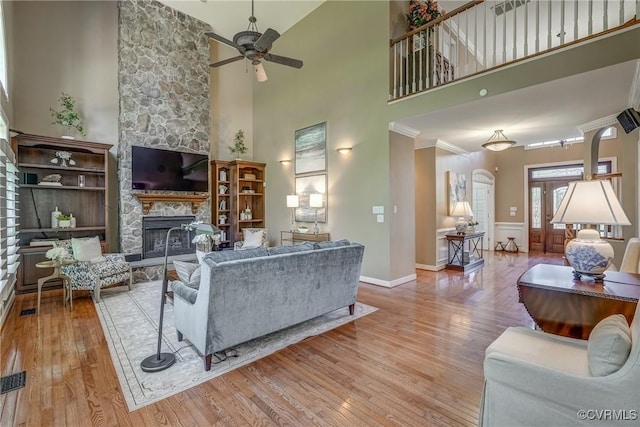 2600 Mulberry Row Rd, Midlothian, VA 23113 - living area with ceiling fan, a fireplace, wood finished floors, a towering ceiling, and baseboards