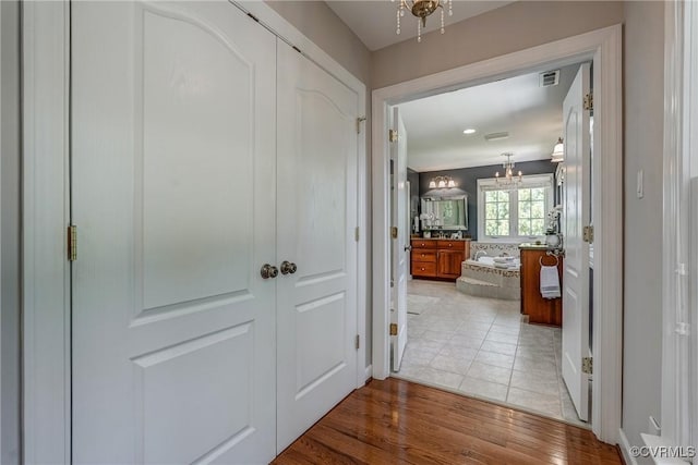 2600 Mulberry Row Rd, Midlothian, VA 23113 - hall with a chandelier and light wood-style flooring
