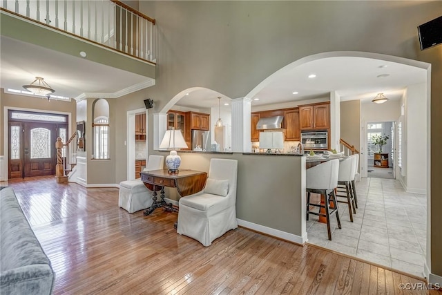 2600 Mulberry Row Rd, Midlothian, VA 23113 - living area featuring arched walkways, light wood-type flooring, baseboards, recessed lighting, and stairway