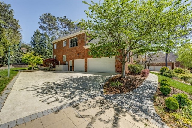 2600 Mulberry Row Rd, Midlothian, VA 23113 - view of side of property with brick siding, concrete driveway, and an attached garage