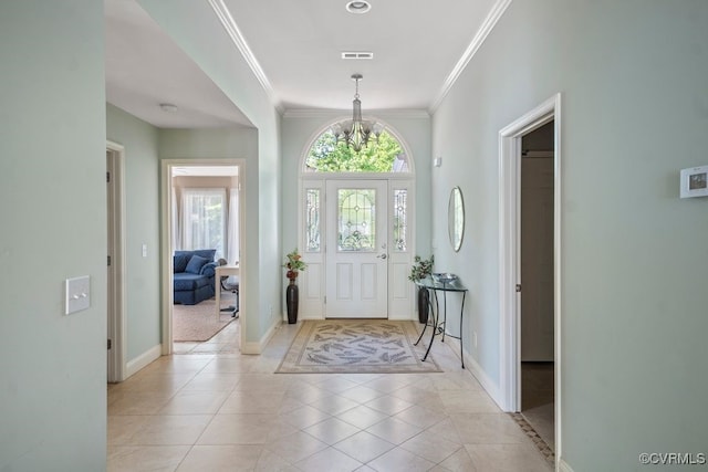 foyer with light tile patterned floors, baseboards, crown molding, and visible vents