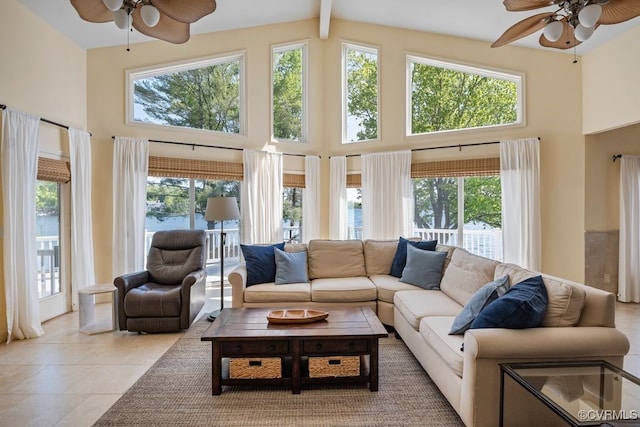 living area featuring ceiling fan, a wealth of natural light, and high vaulted ceiling