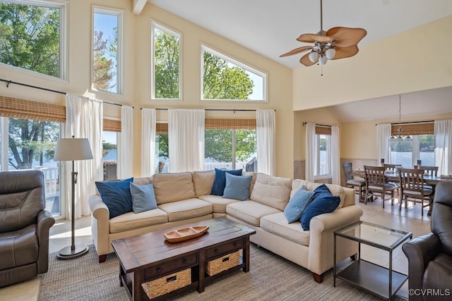 living room featuring high vaulted ceiling, a ceiling fan, and a wealth of natural light