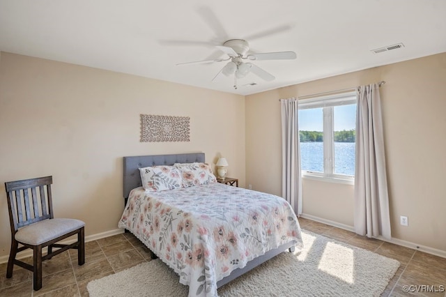 tiled bedroom with baseboards, ceiling fan, and visible vents