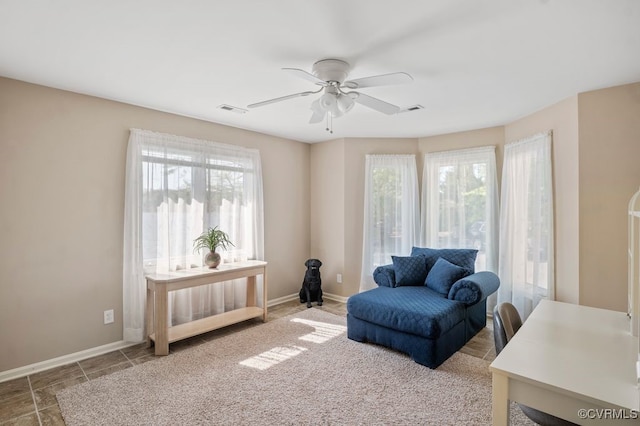 sitting room featuring ceiling fan, visible vents, and baseboards