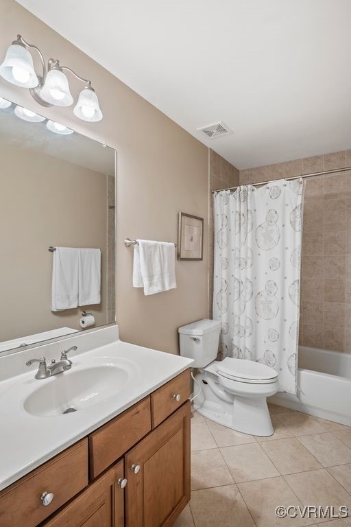 bathroom with visible vents, shower / tub combo, tile patterned floors, vanity, and toilet