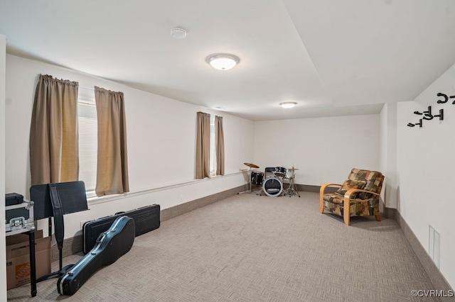 unfurnished room with carpet floors, baseboards, and visible vents