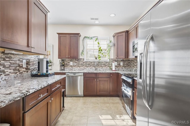 17318 Library Blvd, Ruther Glen, VA 22546 - kitchen with visible vents, a sink, light stone countertops, decorative backsplash, and stainless steel appliances