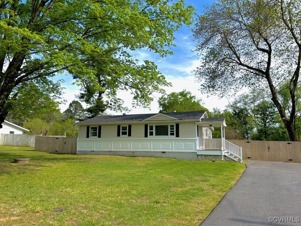 2721 Perlock Rd, Richmond, VA 23237 - view of front of home with fence, a front yard, driveway, and crawl space