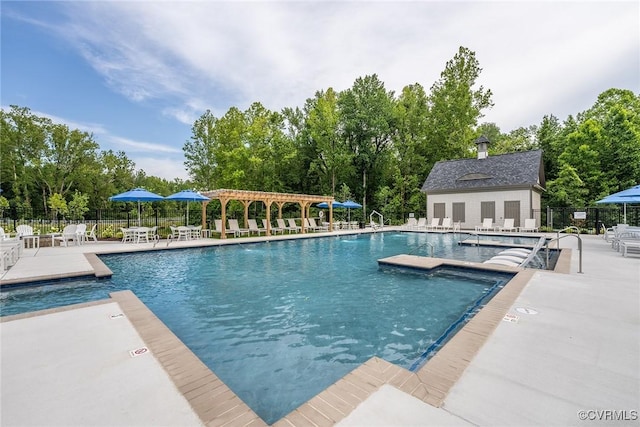 community pool with a patio and fence
