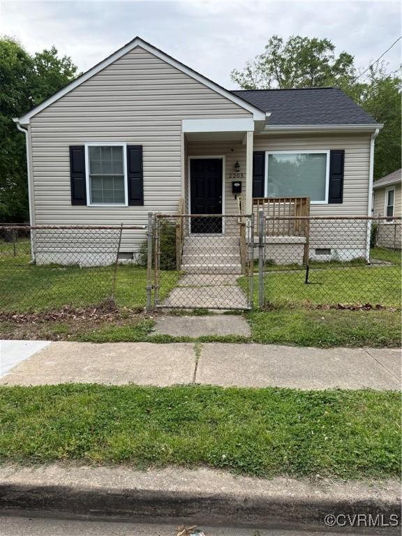 bungalow-style home featuring crawl space, a fenced front yard, a front lawn, and a gate