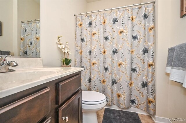full bath with tile patterned floors, curtained shower, vanity, and toilet