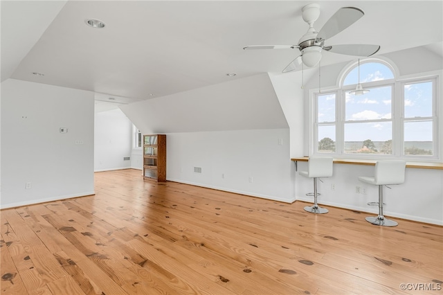 additional living space with lofted ceiling and baseboards