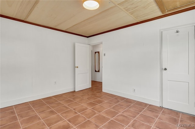 tiled spare room with baseboards and crown molding