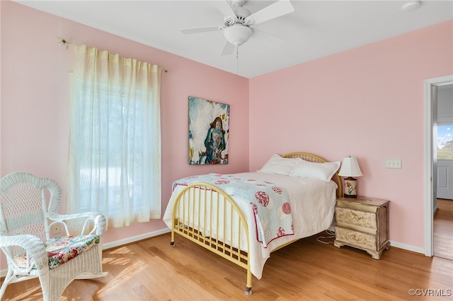 bedroom featuring wood finished floors, ceiling fan, and baseboards