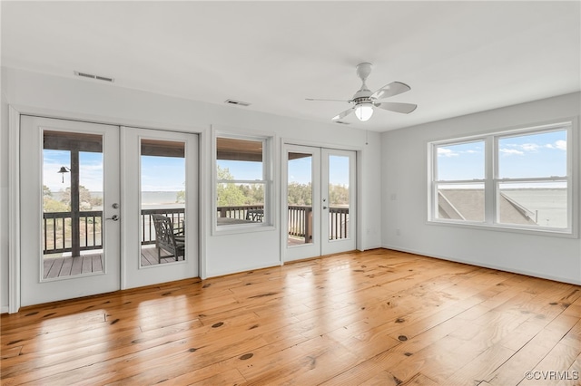 interior space with french doors, visible vents, and a ceiling fan