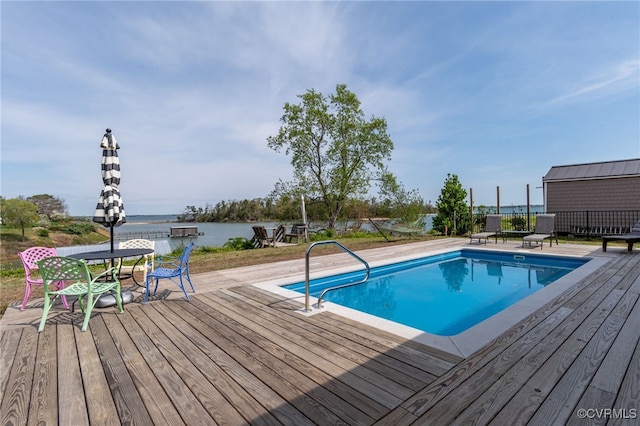 outdoor pool featuring a deck with water view