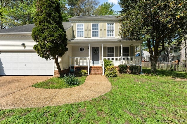 colonial-style house with driveway, an attached garage, a front yard, fence, and covered porch