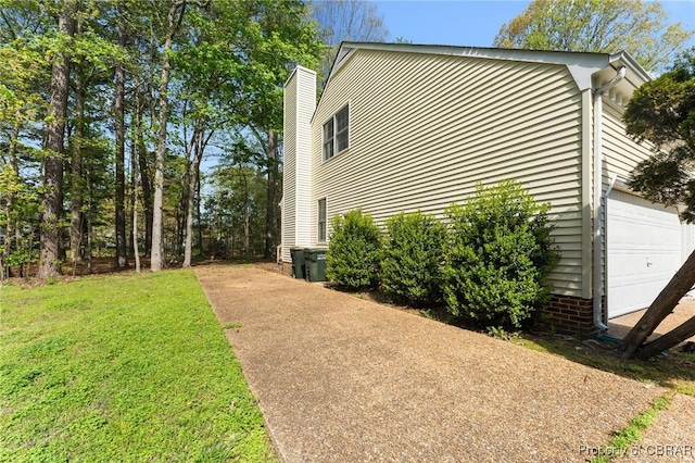 view of property exterior with a garage, a yard, and a chimney