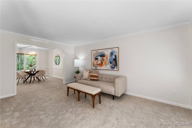 carpeted living area featuring ornamental molding and baseboards