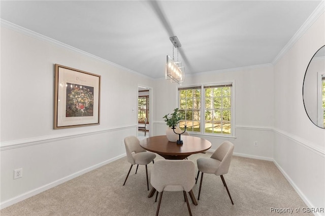 carpeted dining space featuring baseboards and ornamental molding