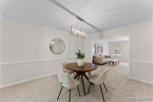 dining room with ornamental molding, baseboards, and carpet floors