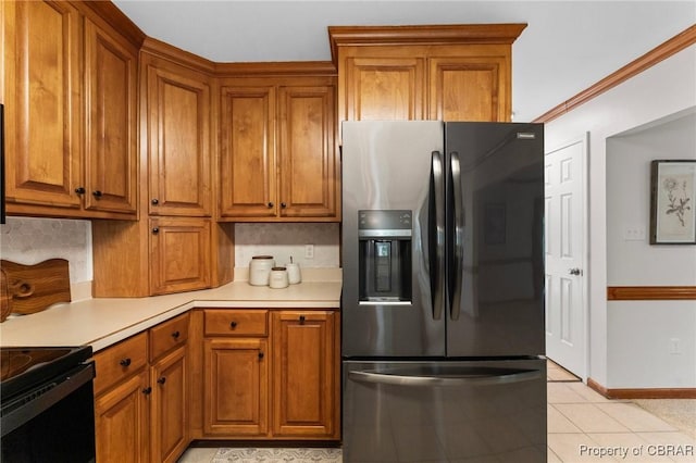 kitchen featuring light countertops, brown cabinets, and black appliances