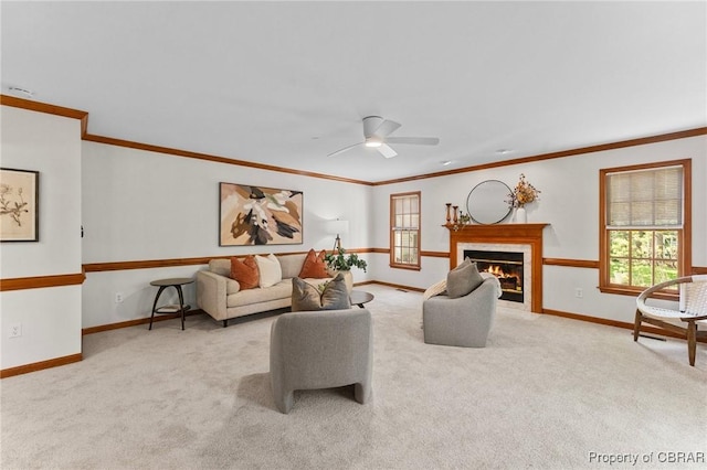 carpeted living area with a fireplace with flush hearth, baseboards, crown molding, and a healthy amount of sunlight