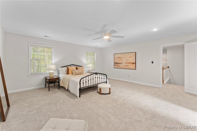bedroom with light carpet, ceiling fan, baseboards, and visible vents