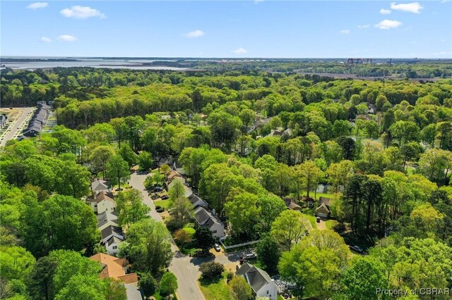 drone / aerial view featuring a wooded view
