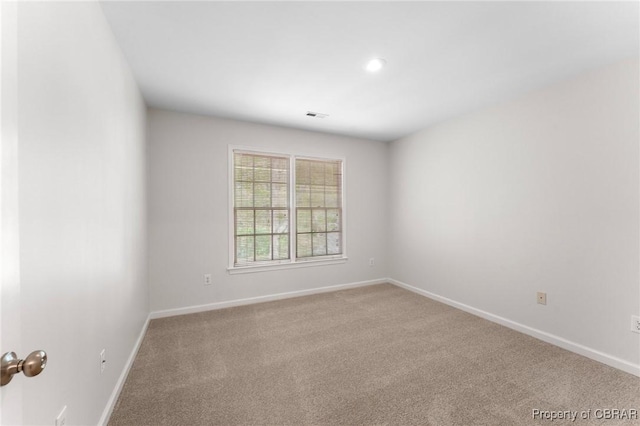 spare room featuring recessed lighting, baseboards, visible vents, and carpet