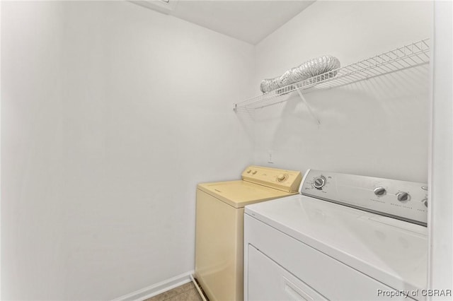 laundry room with washing machine and dryer, laundry area, and baseboards