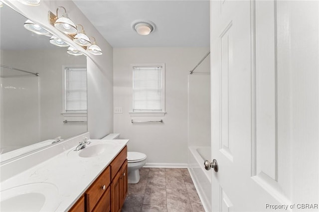 full bath featuring toilet, a sink, shower / washtub combination, double vanity, and baseboards