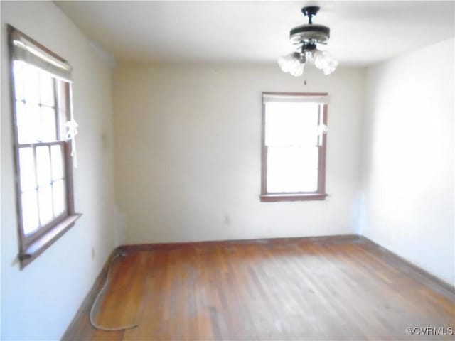 unfurnished room with wood finished floors
