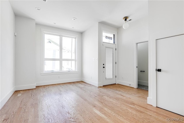foyer featuring light wood-style flooring and baseboards