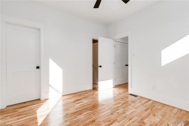 unfurnished bedroom featuring light wood-style floors, ceiling fan, and visible vents