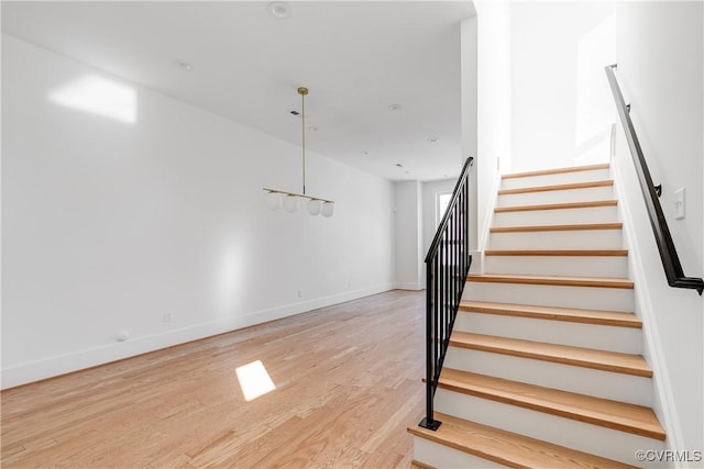 stairs featuring baseboards and wood finished floors
