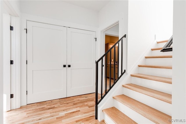 foyer featuring light wood-style floors and stairs