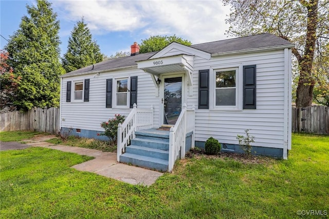 bungalow-style home with fence, crawl space, and a front yard