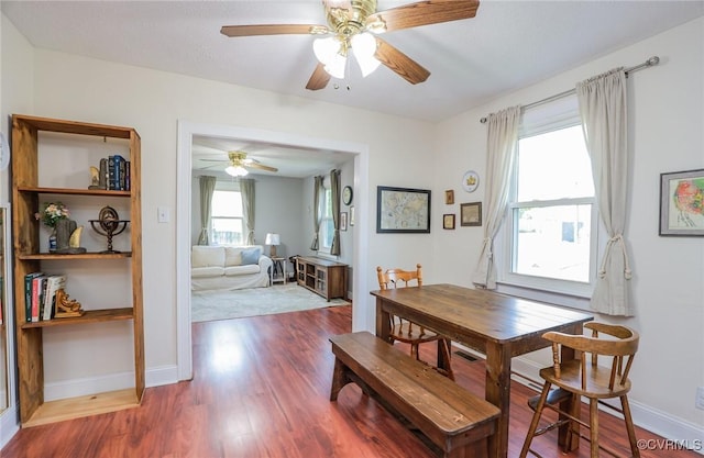dining room featuring baseboards, ceiling fan, and wood finished floors