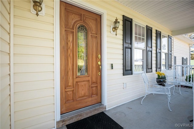 view of exterior entry with a porch